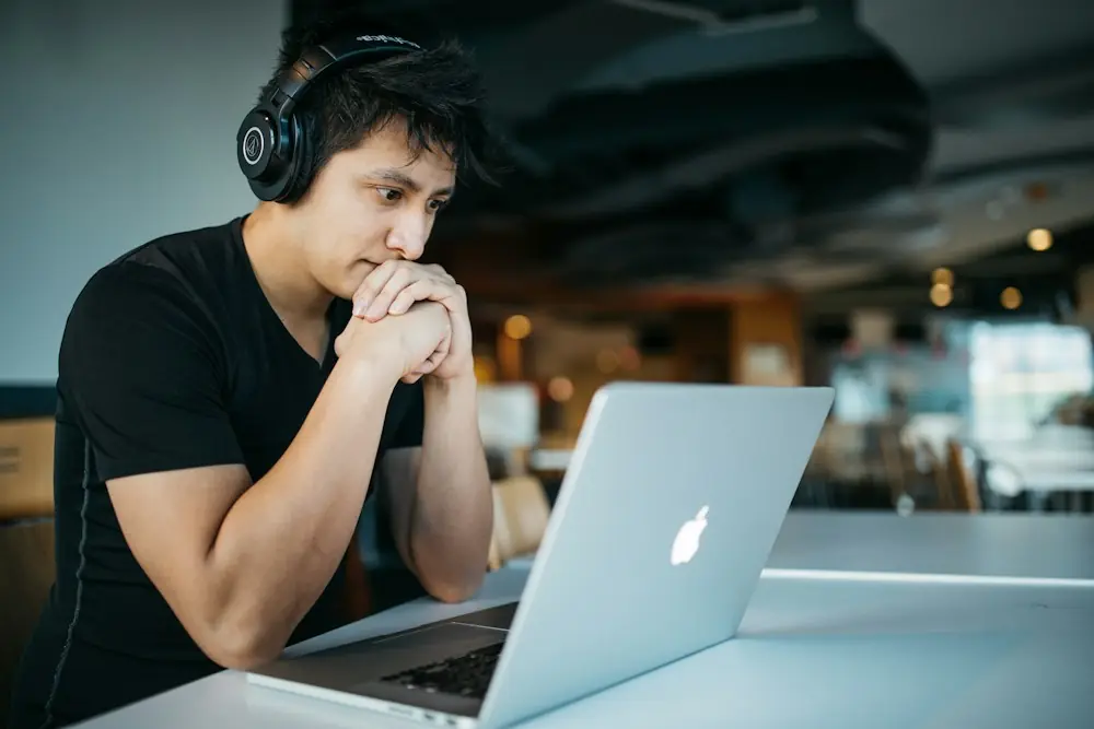 Learner studying an online course on a laptop with headphones